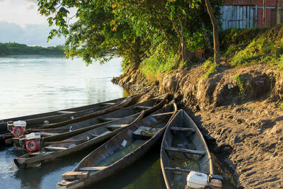 Boats moored in river