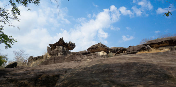 Low angle view of rock formations against sky