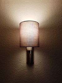 Close-up of illuminated lamp mounted on wall