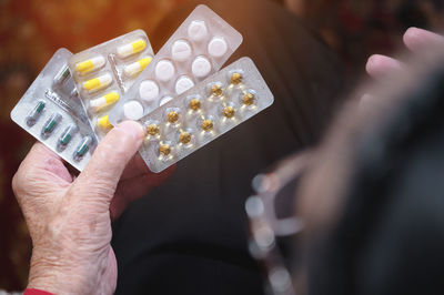 Cropped hand of woman holding medicines