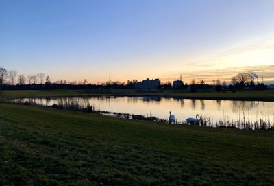 Scenic view of lake against sky during sunset