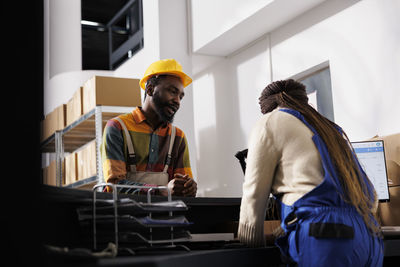 Side view of young woman working in office