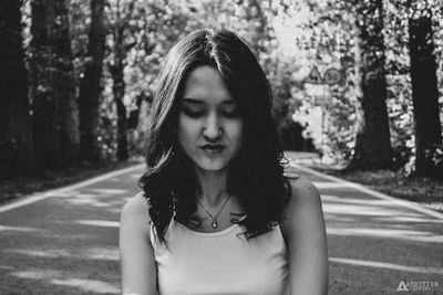 Portrait of young woman looking away outdoors