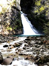 Scenic view of waterfall against sky