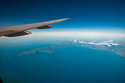 Aerial view of mountains against blue sky