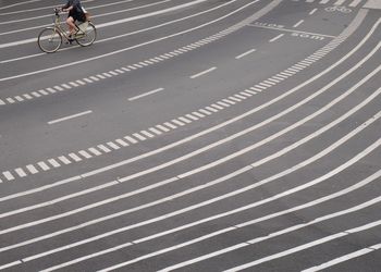 Woman with bicycle on road