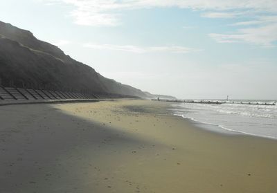 View of calm beach against sky