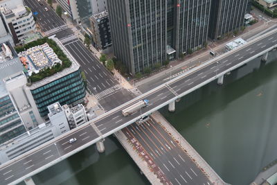 High angle view of bridge over river amidst buildings in city