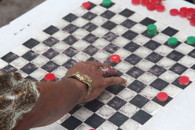 High angle view of man playing on tiled floor