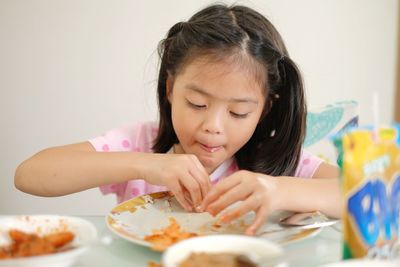 Portrait of girl eating shrimp