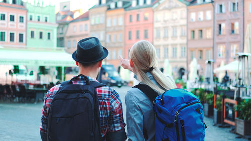 Rear view of man and woman in city