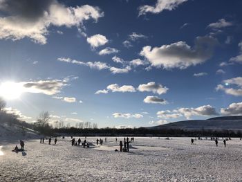 People on beach against sky