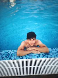 High angle portrait of man swimming in pool