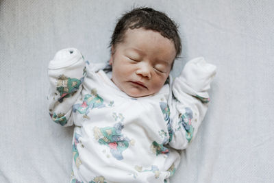 Close-up of baby sleeping on bed