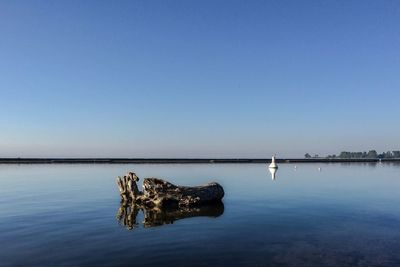 Scenic view of calm sea against clear sky