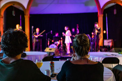 Rear view of people enjoying music concert