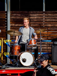 Full length of man sitting at music concert