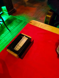 Close-up of hand using mobile phone on table