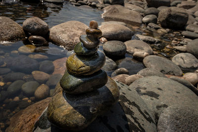 Pyramid of pebbles or stones on river edge