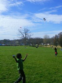 People playing golf on grassy field