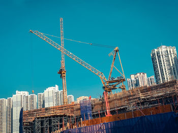 Low angle view of buildings against clear blue sky