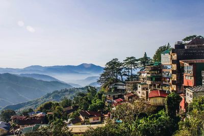 Houses against mountains against clear sky