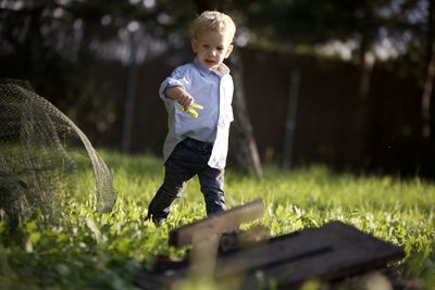 Full length of boy standing on field