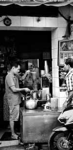 Man and woman standing at market stall