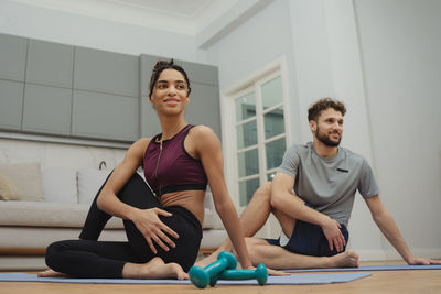 Portrait of young woman exercising in gym
