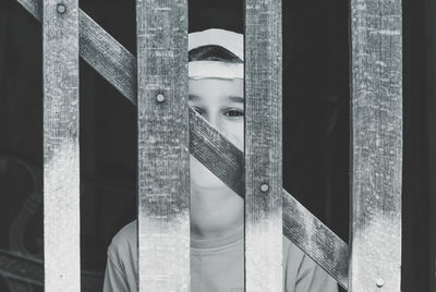 Portrait of boy behind fence