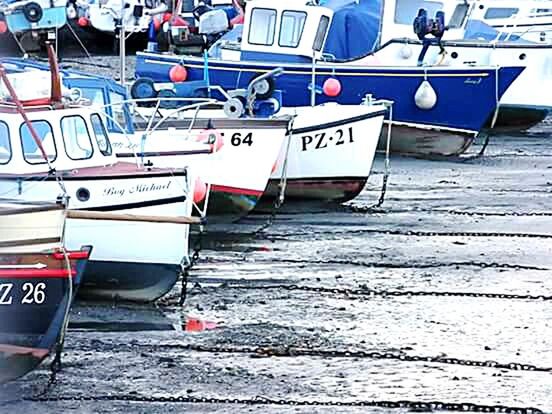 transportation, mode of transport, text, nautical vessel, land vehicle, western script, car, travel, boat, day, communication, moored, stationary, outdoors, high angle view, street, incidental people, sea, sign, wood - material