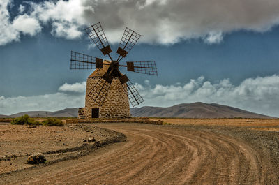 Traditional windmill against sky