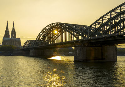 Bridge over river at sunset