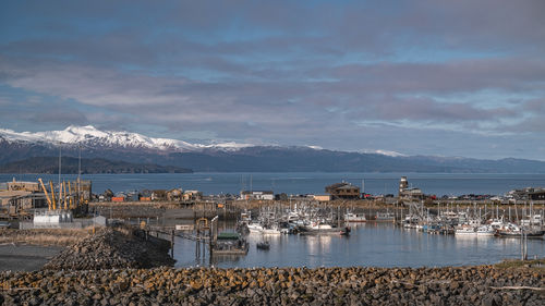 High angle view of townscape by sea against sky