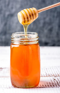 Close-up of honey in glass jar on table