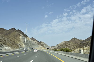 Cars on road against sky