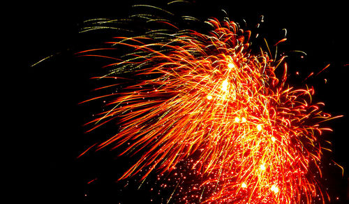 Low angle view of firework display at night
