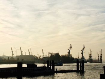 View of harbor against cloudy sky