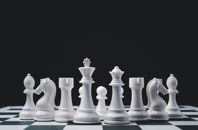 Close-up of chess pieces against black background