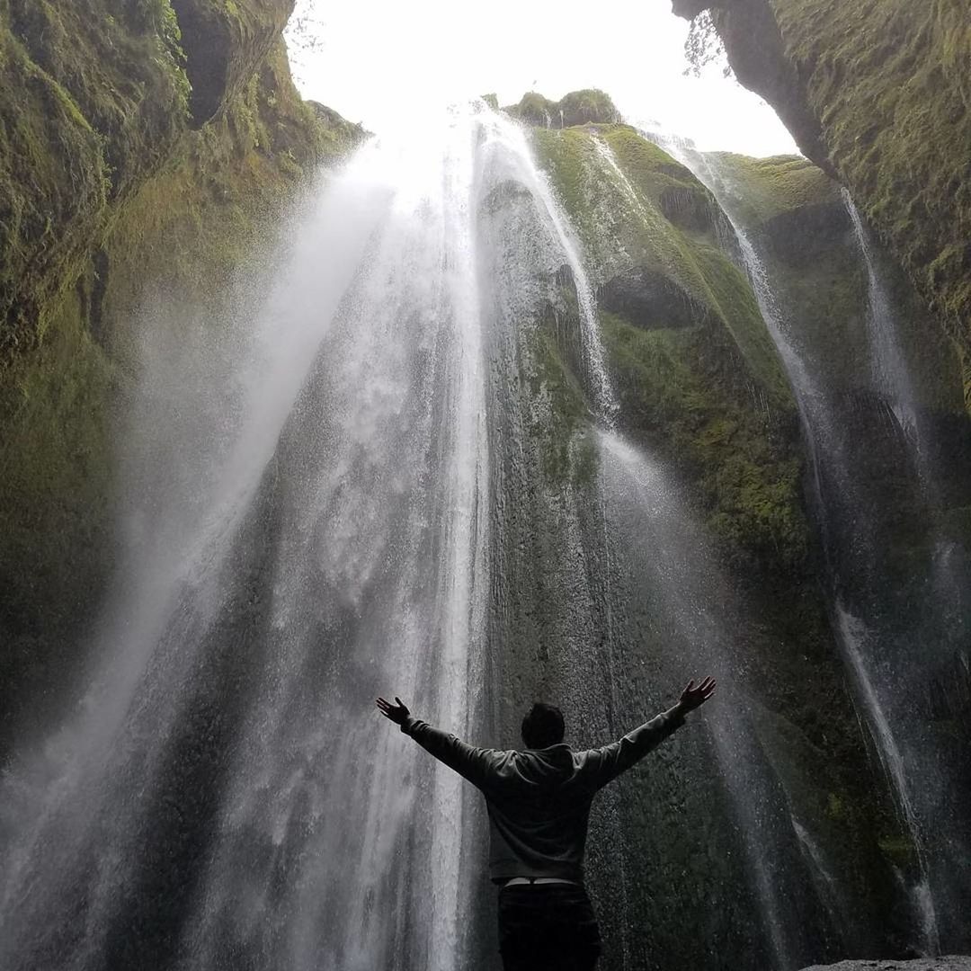 REAR VIEW OF MAN STANDING IN WATER