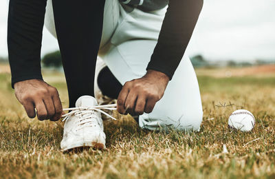 Low section of man standing on grass