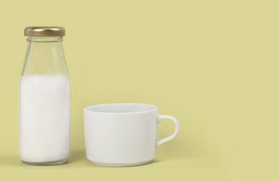 Close-up of glass of bottle against white background