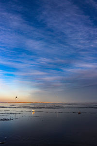 Scenic view of sea against sky at sunset