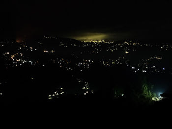 High angle view of illuminated buildings in city at night