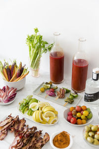 Close-up of food and drink arranged on table against wall