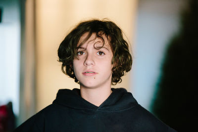 Portrait of a teen girl with short hair and braces looking serious