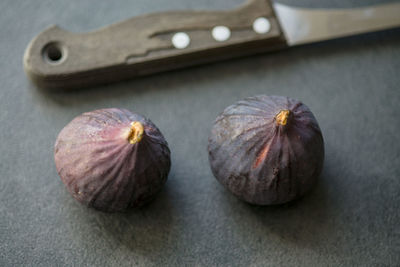 Close-up of figs with knife on table