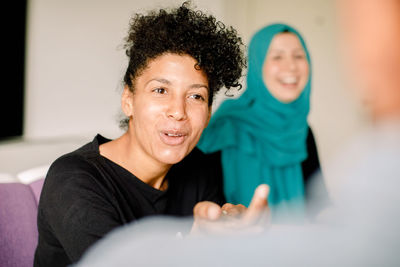 Close-up of businesswoman discussing during meeting in convention center