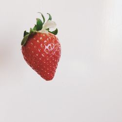 Close-up of strawberry over white background