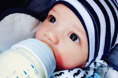 Close-up of cute baby boy drinking milk